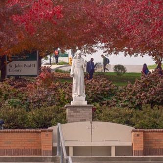 St. Francis Statue for prof’s profiles St. Francis Statue and red leaves on trees
