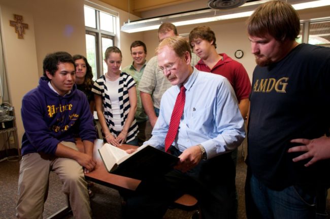 Professor reading with students