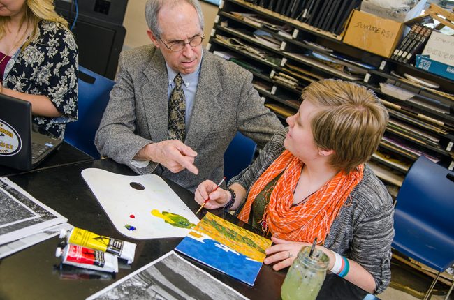 Professor helping in art